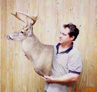 Louisiana taxidermist Paul Eymard and one of his whitetail taxidermy mounts.